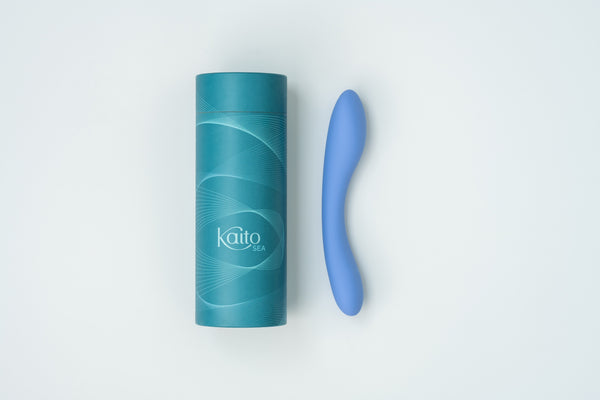 Blue Kaito Sea internal vibrator beside its teal packaging